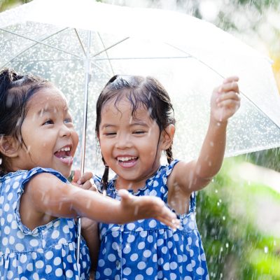 Two,Happy,Asian,Little,Girls,With,Umbrella,Having,Fun,To
